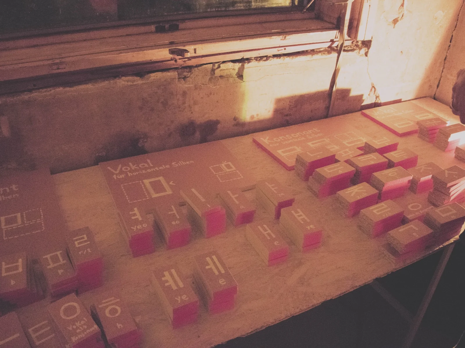 Wooden blocks with Korean letters sorted on boards labelled vowel and consonant